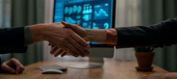mature-financial-advisor-shaking-hand-with-his-cli-2024-10-18-12-56-07-utc